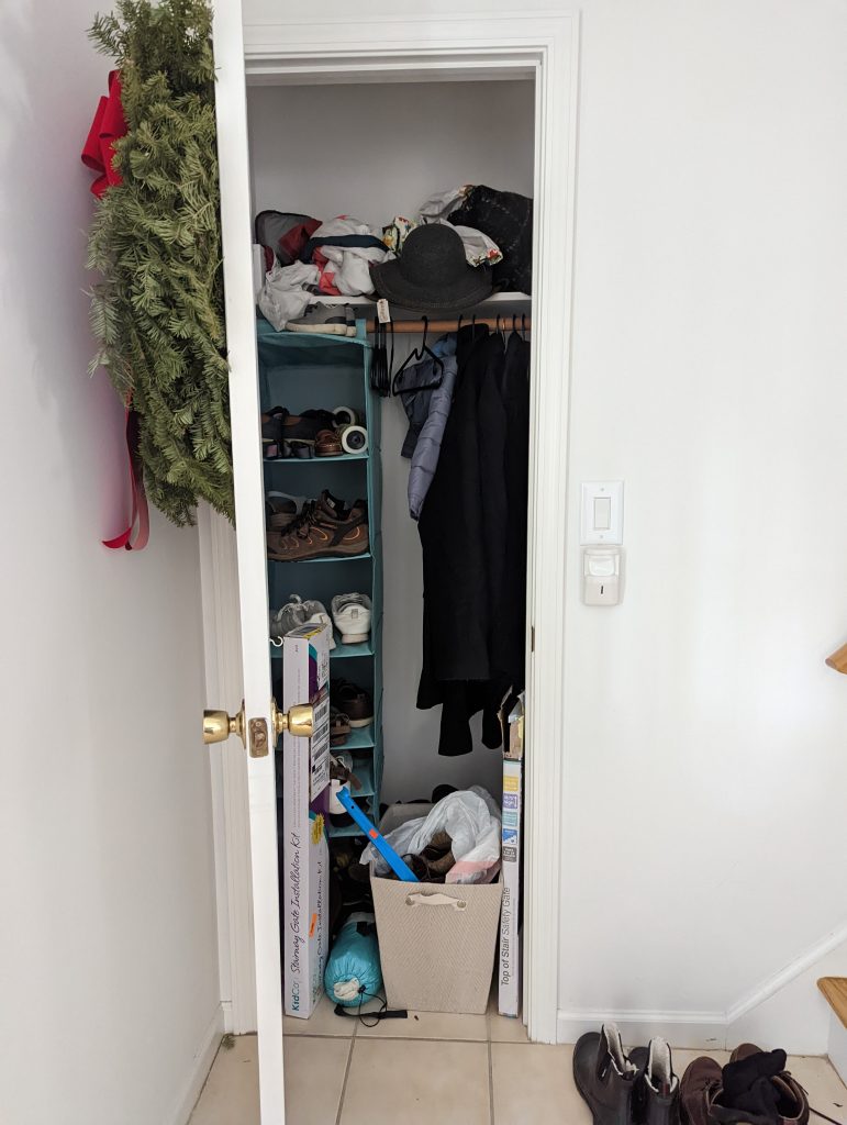 coat closet before organizing our closets
